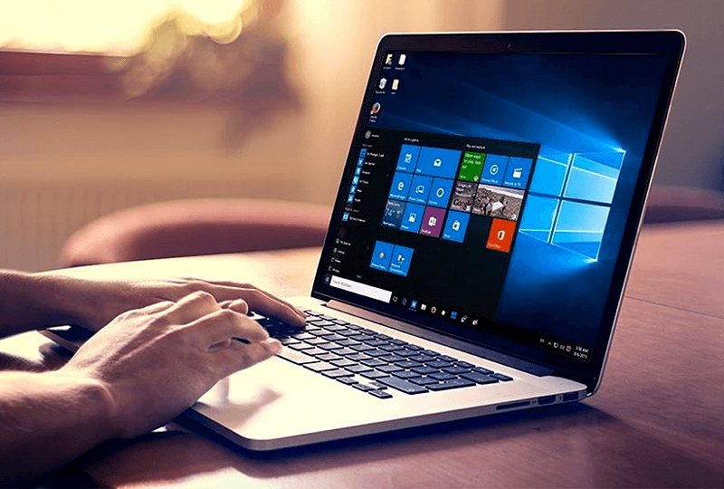 Person interacting with a Windows laptop