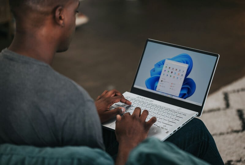 Man working on a windows laptop.